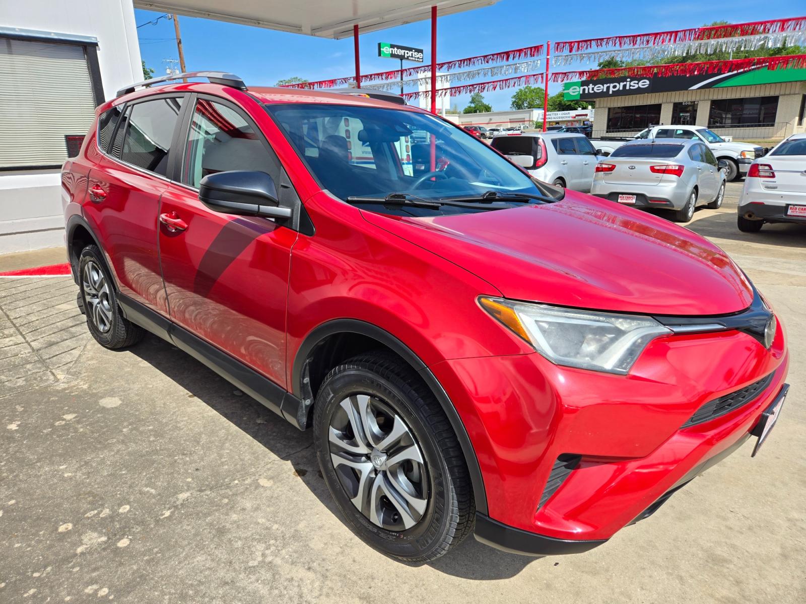 2017 Red Toyota RAV4 LE FWD (2T3ZFREV9HW) with an 2.5L L4 DOHC 16V engine, 6A transmission, located at 503 West Court, Seguin, TX, 78155, (830) 379-3373, 29.568621, -97.969803 - Photo #1
